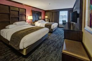 a hotel room with two beds and a flat screen tv at DoubleTree by Hilton Decatur Riverfront in Decatur +28 photos