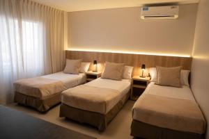 Cama ou camas em um quarto em Urbana Suites mais 20 fotos