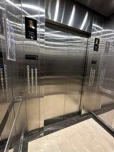 a stainless steel elevator in a building at Condo Unit in BGC Taguig Manila with FREE Covered Parking & WiFi in Manila