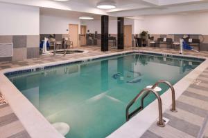 a large swimming pool in a hotel lobby at Hampton Inn & Suites Denver-Speer Boulevard in Denver
