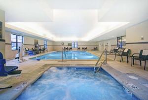 a large indoor swimming pool in a hotel at Homewood Suites by Hilton Denver International Airport in Aurora
