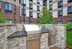 a barbecue grill in front of a building at Homewood Suites by Hilton Denver International Airport in Aurora