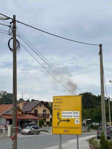 a yellow sign on the side of a street at Apartmani Bella in Krževići