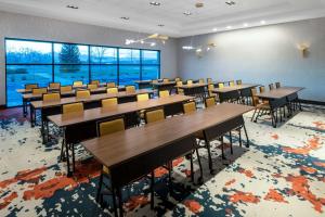 a classroom with rows of tables and chairs at Hilton Garden Inn Longmont in Longmont