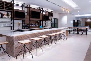 a bar in a restaurant with stools at Hilton Garden Inn Longmont in Longmont