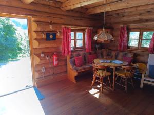 a dining room in a log cabin with a table and chairs at Blockhaustraum in Titisee-Neustadt