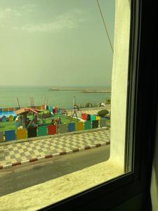 a view of a playground from a window at Résidence artistique Vue sur mer in Larache