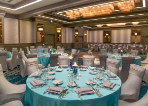a ballroom with round tables and white chairs at DoubleTree by Hilton Hotel Deerfield Beach Boca Raton in Deerfield Beach