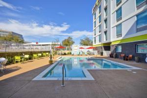 a swimming pool in front of a building at Home2 Suites By Hilton Dallas North Park in Dallas