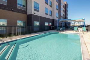 a swimming pool in front of a building at Tru By Hilton Coppell DFW Airport North in Coppell