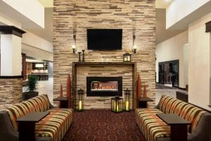 a lobby with couches and a fireplace with a tv at Hilton Garden Inn Denison/Sherman/At Texoma Event Center in Sherman