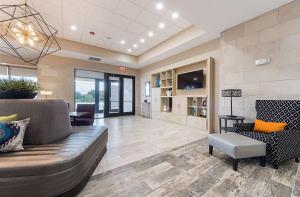 a living room with a couch and a chair at Home2 Suites By Hilton Dallas Grand Prairie in Grand Prairie