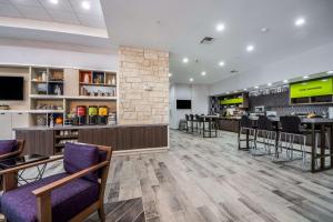 a lobby with a bar and a restaurant at Home2 Suites By Hilton Fort Worth Northlake in Roanoke