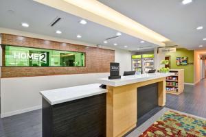 a lobby of a library with a counter in a store at Home2 Suites By Hilton Fort Worth Southwest Cityview in Fort Worth