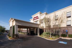 a hotel building with a parking lot in front of it at Hampton Inn & Suites Dothan in Dothan