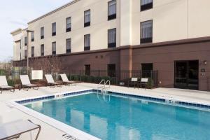 a swimming pool in front of a building at Hampton Inn & Suites Dothan in Dothan