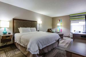 a hotel room with a large bed and a window at Hampton Inn Dickson in Dickson