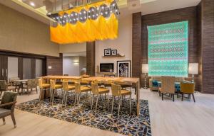 uma sala de jantar com uma grande mesa e cadeiras em Hampton Inn & Suites Dallas-The Colony em The Colony