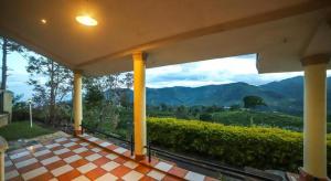 a view of the mountains from a house balcony at The Orange Home in Kotagiri