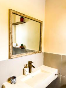 a bathroom with a sink and a mirror at Casa Talisay in General Luna