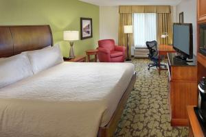 um quarto de hotel com uma cama e uma televisão em Hilton Garden Inn Danbury em Danbury