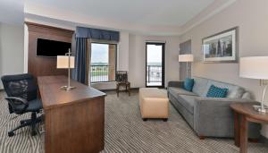 a living room with a couch and a desk at Hampton Inn & Suites Des Moines Downtown in Des Moines