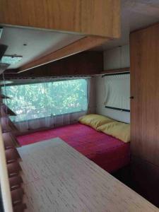 a room with a bed and a window in an rv at Home Shanti, relax tra i ciliegi in Crespellano