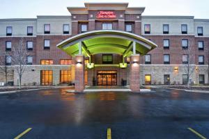 a hotel building with a parking lot in front of it at Hampton Inn & Suites Detroit-Canton in Canton