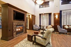 a living room with a fireplace and a tv at Hampton Inn & Suites Detroit-Canton in Canton