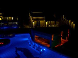 a night view of a swimming pool with blue lights at Sea Sun in Plomari