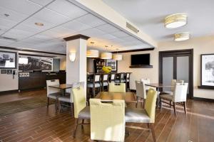 a dining room with a table and chairs at Hampton Inn Detroit Northville in Northville