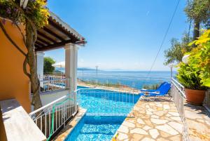 a pool with a view of the ocean from a house at Villa Elia in Nisakion