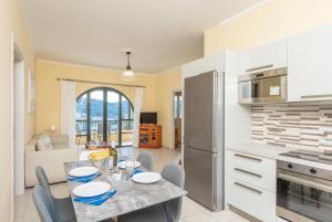 a kitchen and dining room with a table and chairs at Katerina in Dalietátika