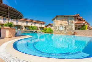 a swimming pool in front of a building at Villa Melek Paradise in Dalyan