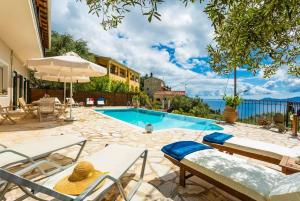 a house with a swimming pool and a patio at Villa Katerina in Katávolos