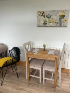 a dining room table with two chairs and a table with at Belle Vue Cottage sleeps 2 one dog by prior permission in Barnard Castle