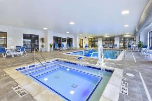 a large swimming pool in a large building with a pool at Hampton Inn Detroit/Southgate in Southgate