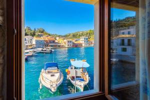 a view of a harbor from a window at Spiros Jetty House in Longós +11 photos