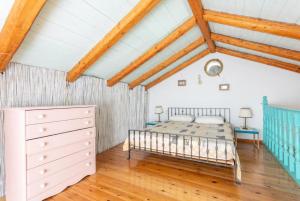 a bedroom with a bed and a wooden floor at Spiros Jetty House in Longos