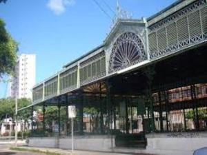 a large building with a bridge over a street at Helbor My Way - Compactos de luxo in Fortaleza