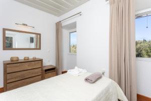 a bedroom with a bed and a dresser and a window at Villa Constadina Large Private Pool AC WiFi in Mastorátika +55 photos