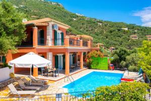 a villa with a swimming pool and a mountain at Villa Youla in Nisaki