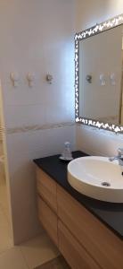 a bathroom with a sink and a mirror at Appartamento di Anna in La Spezia