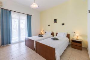 Ένα ή περισσότερα κρεβάτια σε δωμάτιο στο Villa Armandos