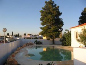 a swimming pool in the backyard of a house at Quinta Teresinha in Estômbar