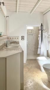 a bathroom with a sink and a toilet and a shower at Cà Mì Apartment in Galatone