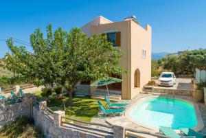 a villa with a swimming pool and a house at Villa Neria in Áptera