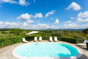 einen Pool mit Stühlen, einem Tisch und einem Sonnenschirm in der Unterkunft Villa Caporlese in Terni