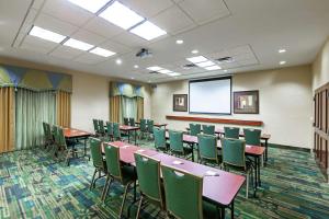 a conference room with tables and chairs and a screen at Hampton Inn & Suites El Paso West in El Paso