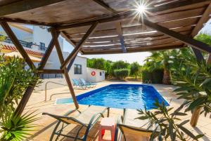 a patio with chairs and a swimming pool at Villa Charoula Pente in Paphos